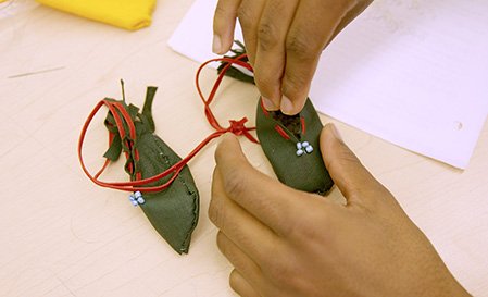 A student making moccasins