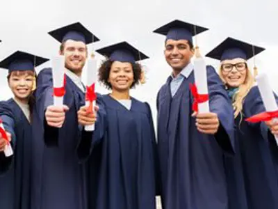 Graduating students with diplomas