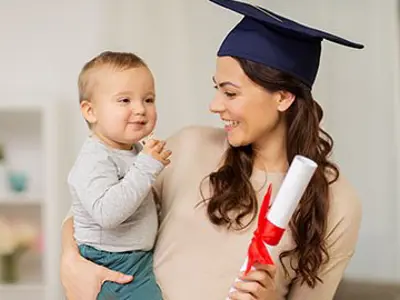 A young mom holding a child and diploma