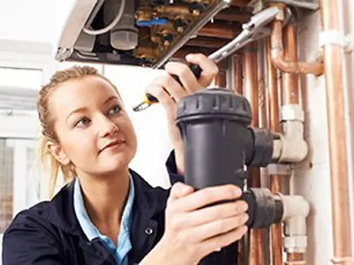 A student working on plumbing