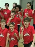 Male volleyball players holding medals