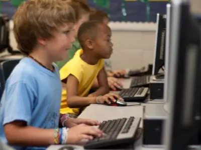 Two children working in a computer lab