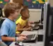 Two children working in a computer lab