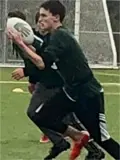 Boy running with rugby ball