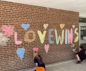 chalk picture on school walls with words "love wins"