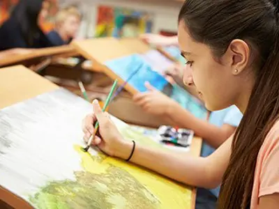 A girl painting a landscape