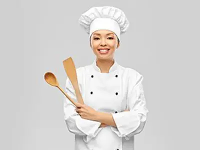 A young chef with cooking utensils