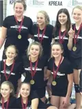 Female volleyball players wearing medals