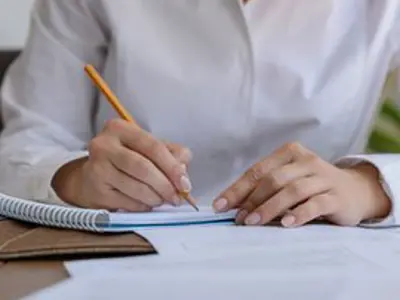 Person writing in a notebook