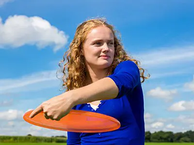 female student throwing frisbee