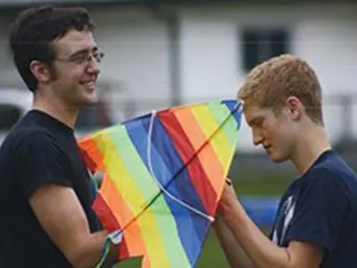 2 students holding a kite