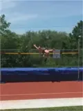 Student jumping over the high jump