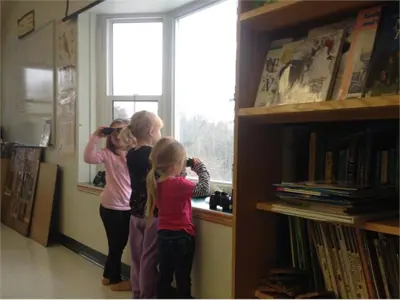 Children looking out the window with binoculars