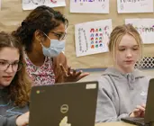 Students working on chromebooks with their teacher